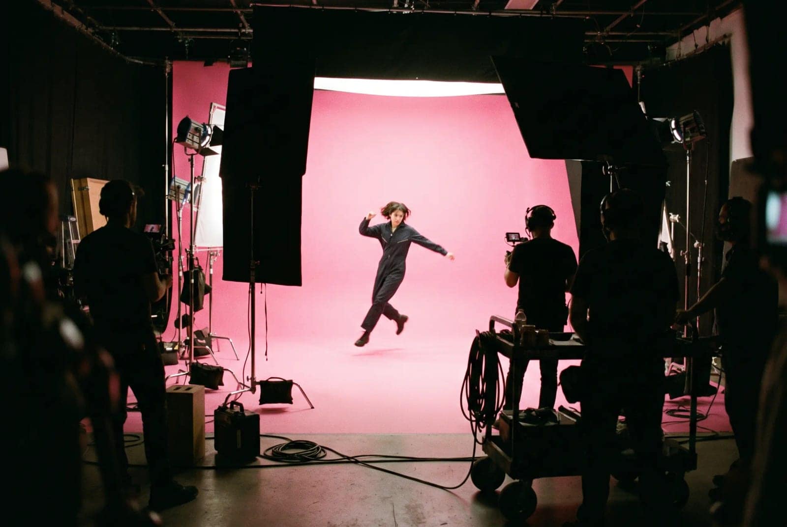 Film Set Behind The Scenes, The whole rig visible around a subject lit on a coloured backdrop